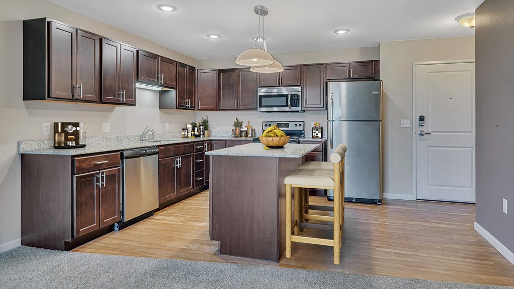 a kitchen with stainless steel appliances and wooden cabinets