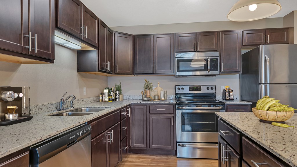 a modern kitchen with stainless steel appliances and granite counter tops