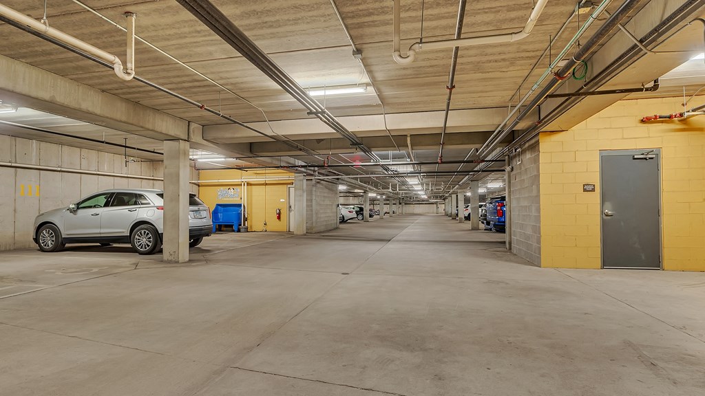 the inside of a parking garage with cars parked in it