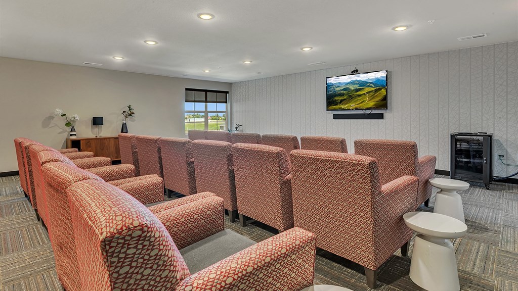 a meeting room with chairs and a television on the wall
