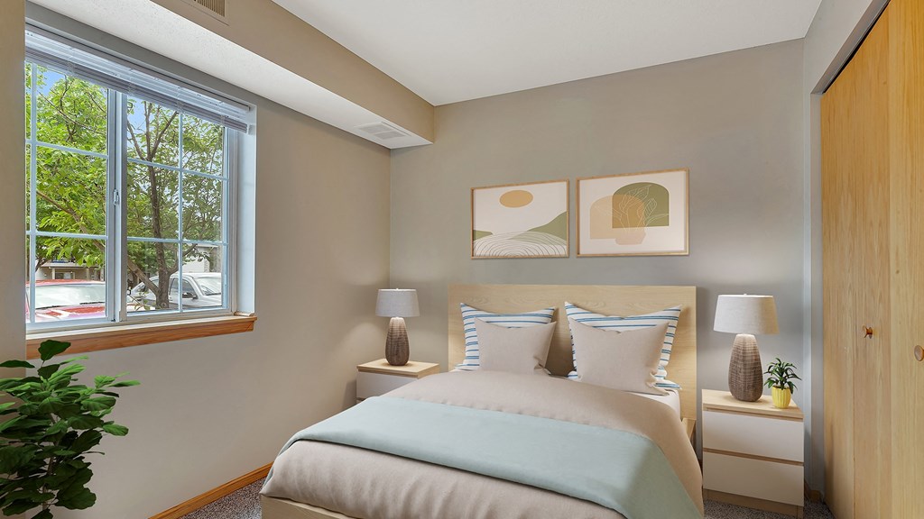 a bedroom with a bed and a large window