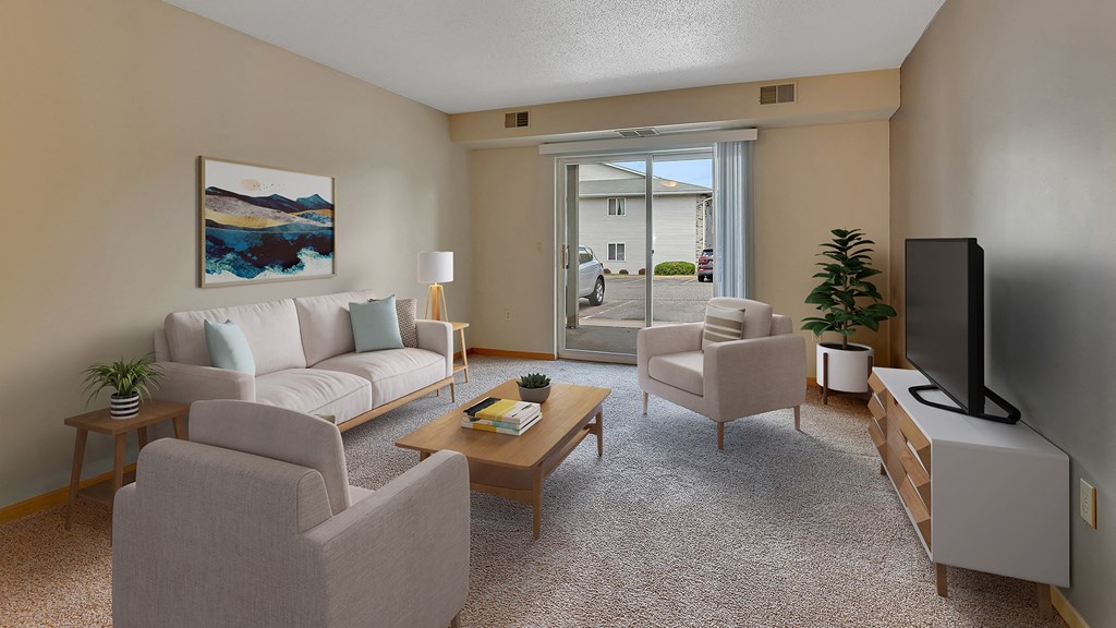 a living room with a couch and chairs and a tv
