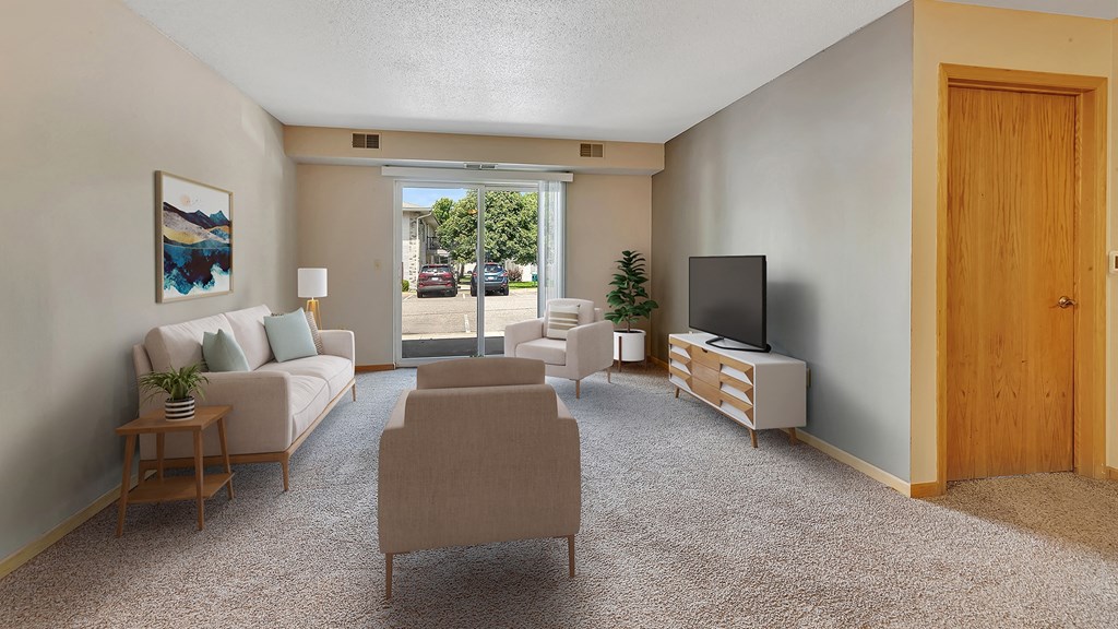 a living room with a couch and chairs and a television