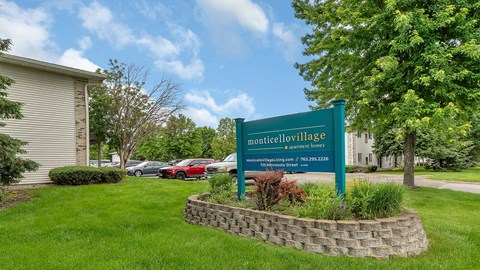 a sign sits in the grass in front of a building