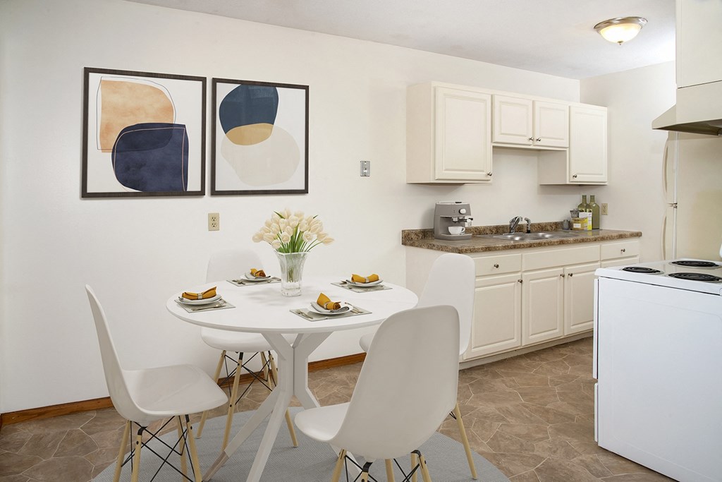 a kitchen and dining area with a table and chairs