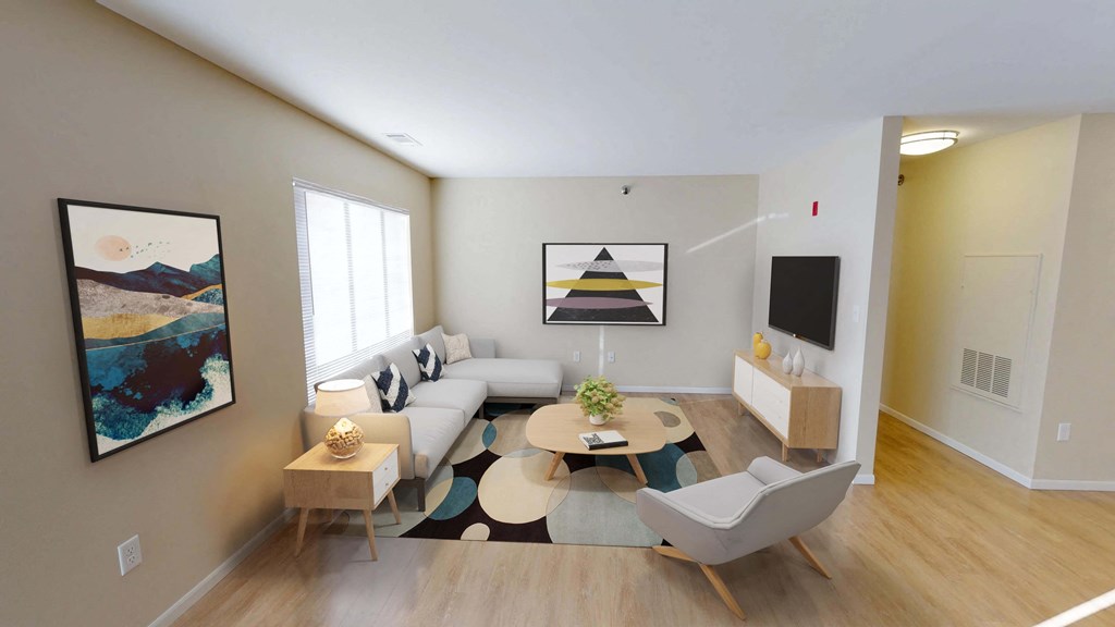Open living space with bright natural light from large window on left wall.