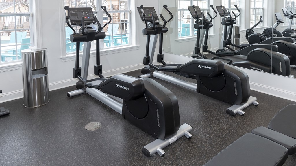 a group of exercise machines in a gym