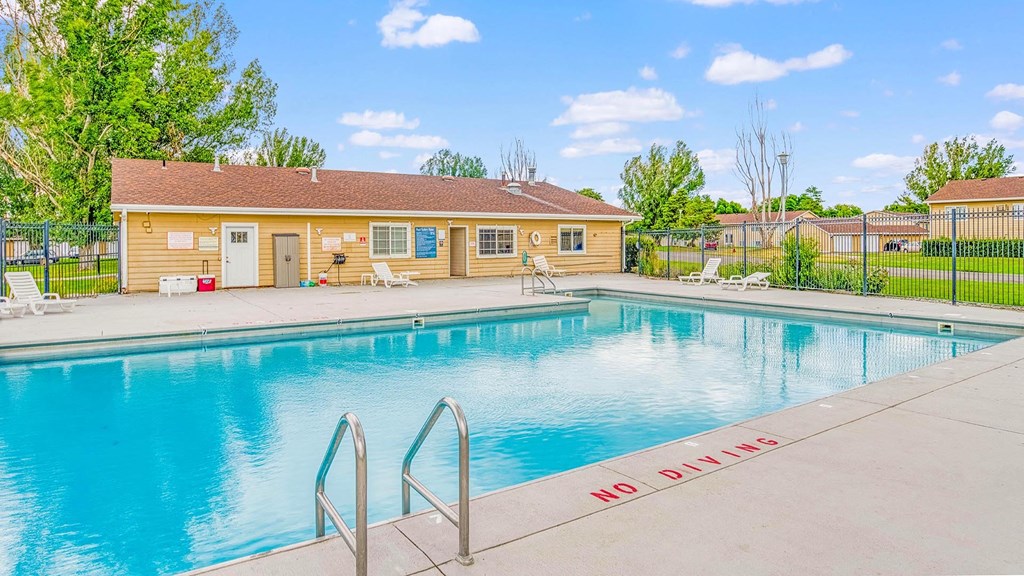 our apartments have a swimming pool with a building in the background