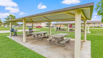 a picnic area with benches and a pavilion