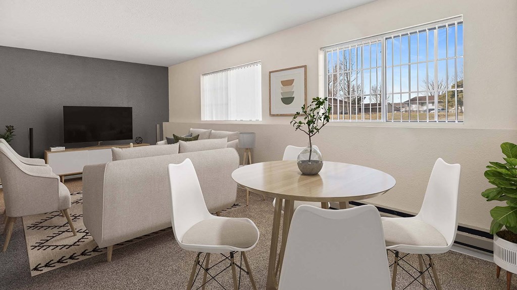 a living room with a table and chairs