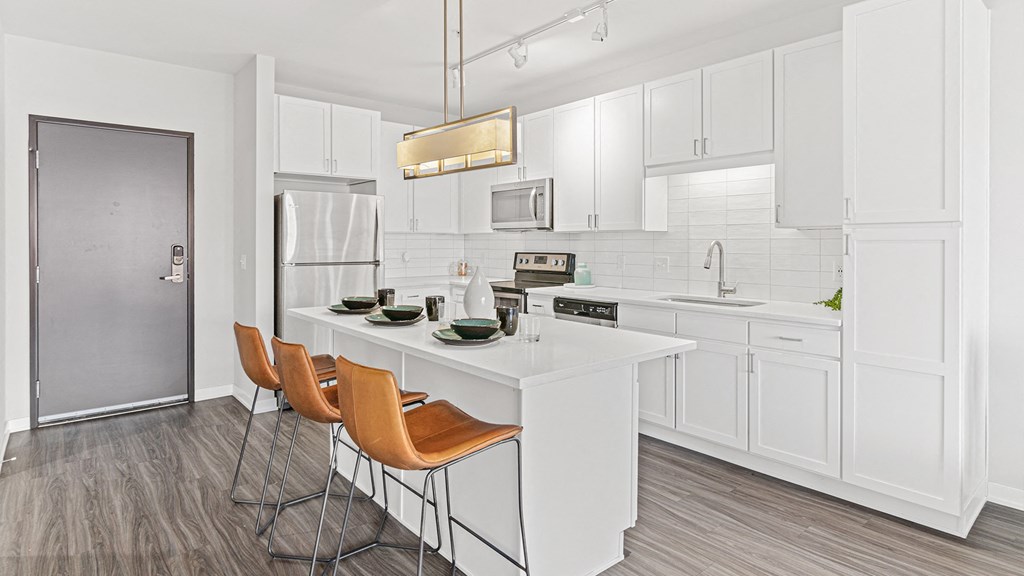 a kitchen with white cabinets and a white counter top