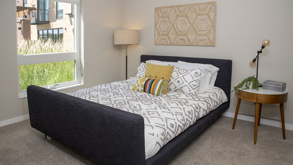 a bedroom with a bed and a window