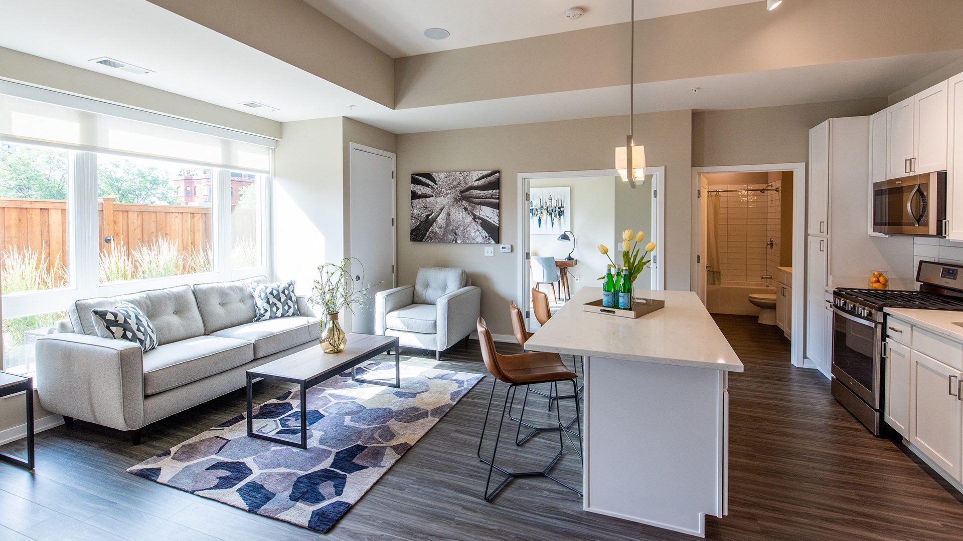 a living room and kitchen with a couch and a table