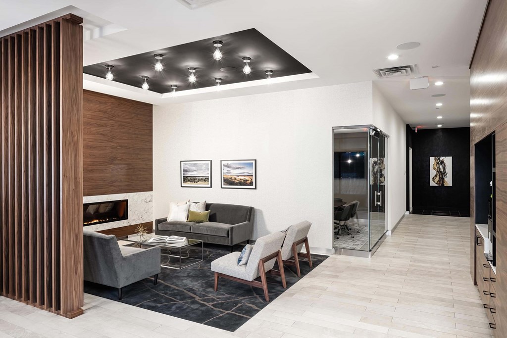 Cozy and sleek fireplace lounge in the lobby with white walls.