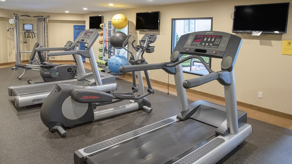 a room with two treadmills and two exercise bikes