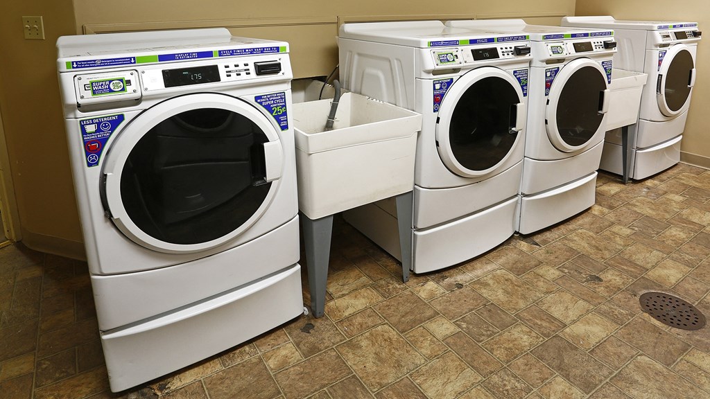 a row of washing machines in a laundromat
