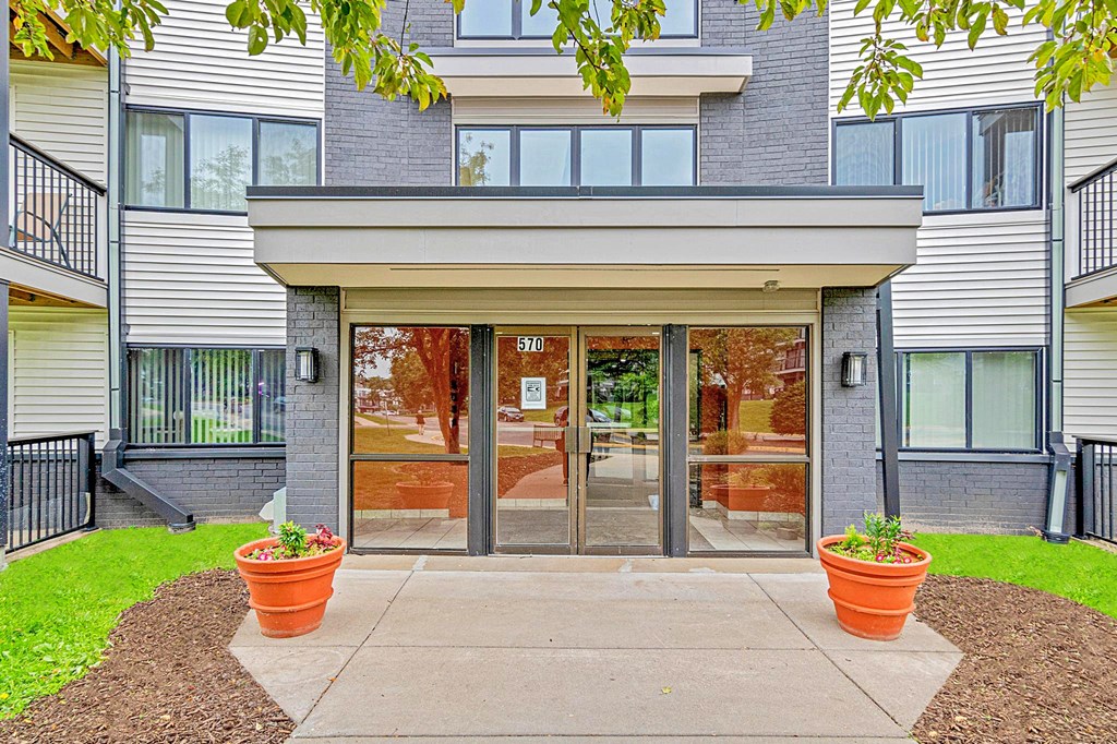 The front of a building with a glass door and windows.