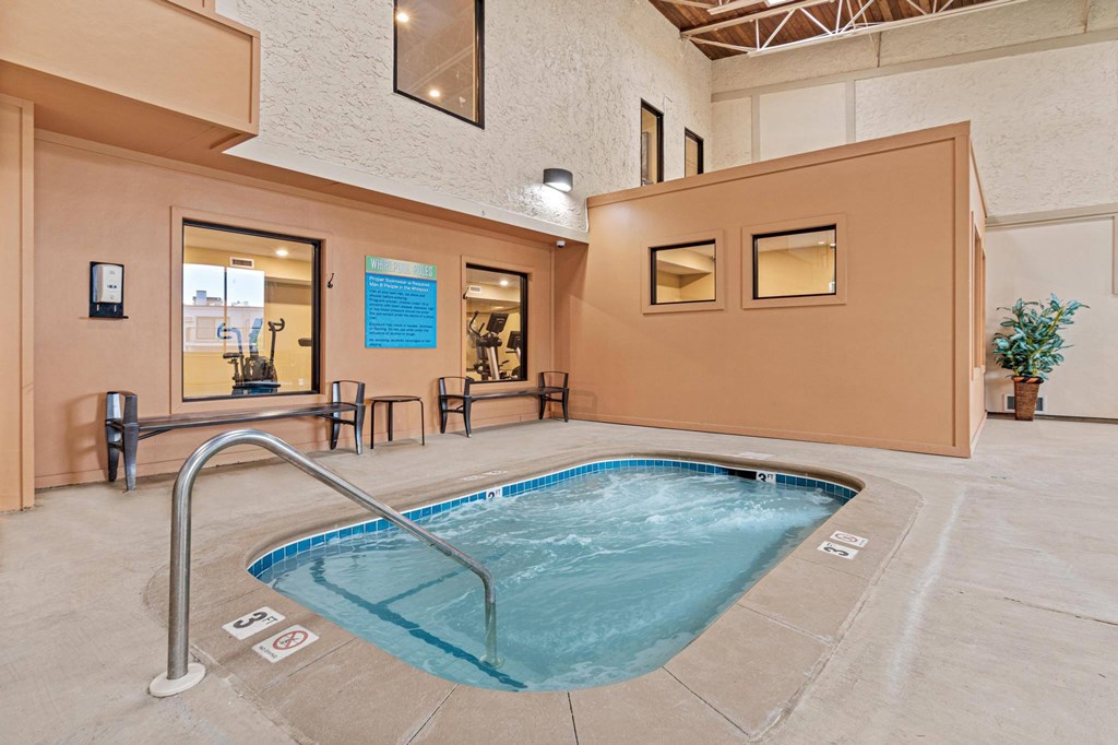 A small indoor pool with a metal railing.