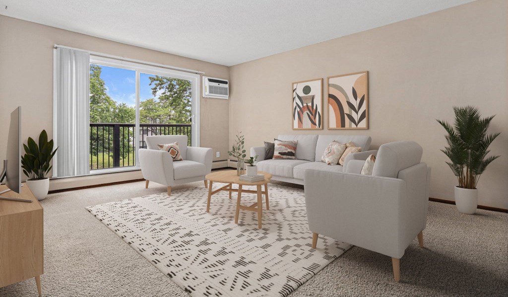 A living room with a white couch, a coffee table, and a television.