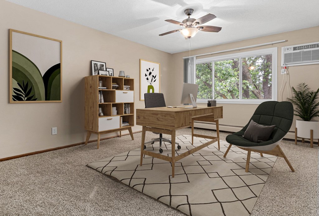 A room with a desk, chair, and a rug.