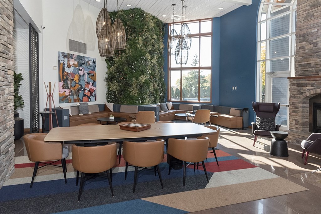 a conference room with a large table and chairs and a fireplace