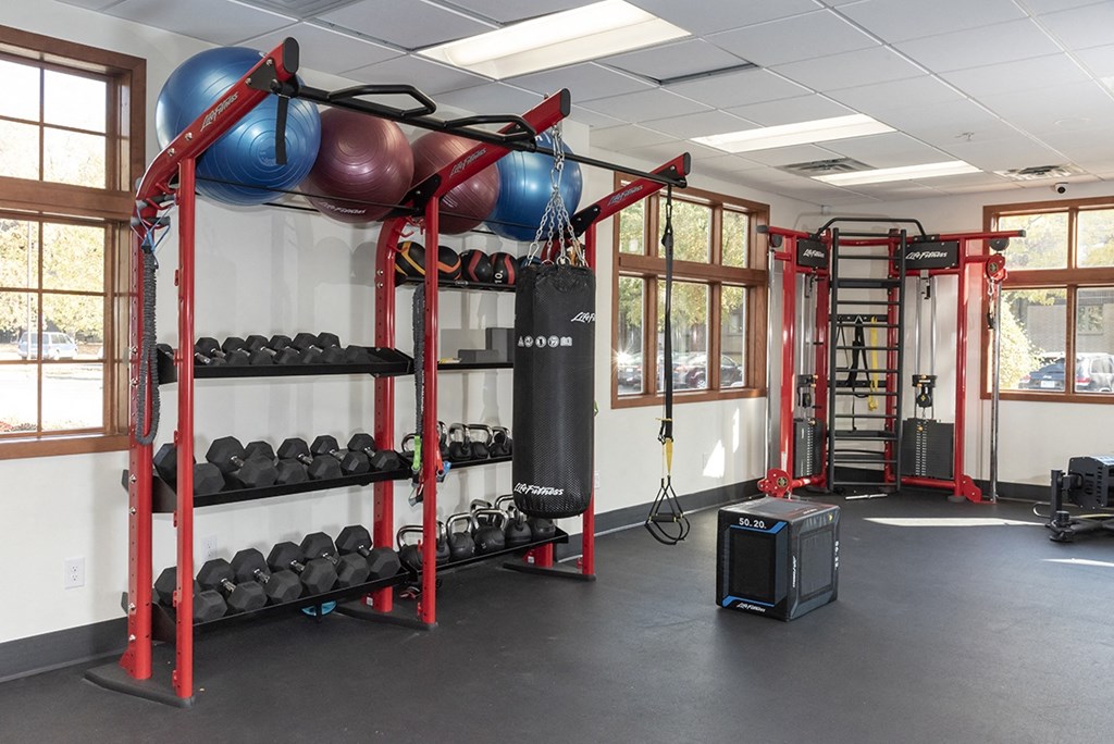 a fitness room with weights and a punching bag