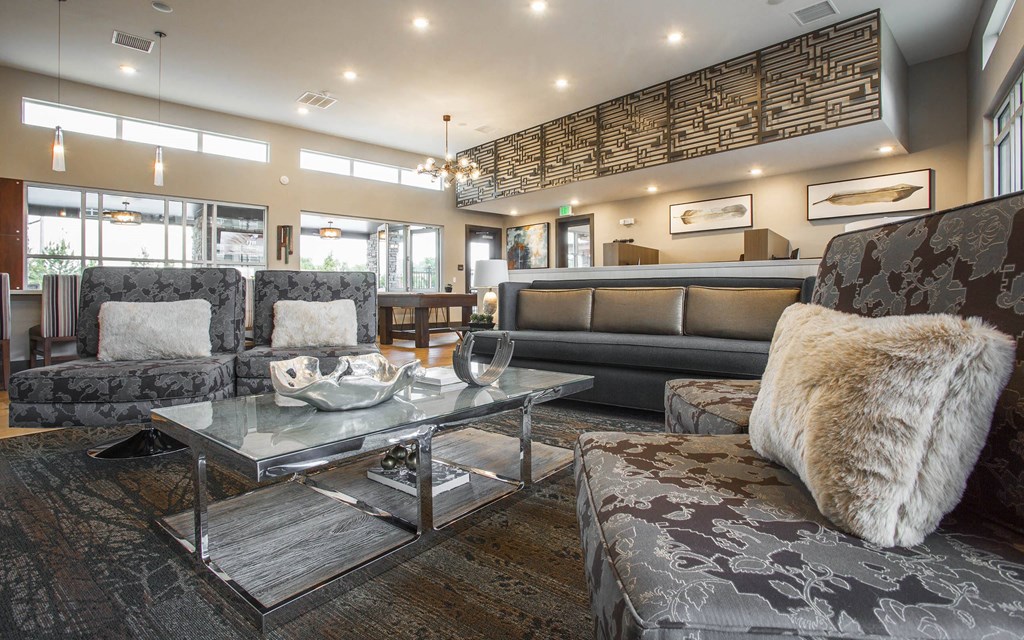 Decorative sofa chairs and glass coffee table in middle of clubhouse