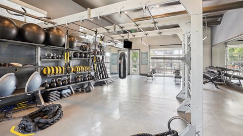 the interior of a gym with weights and racks of equipment