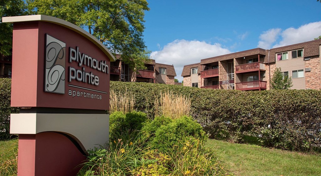 Plymouth Pointe monument sign surrounded by lush greenery