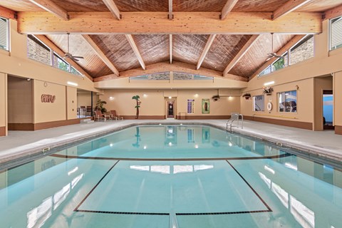 A large indoor swimming pool with a glass bottom.