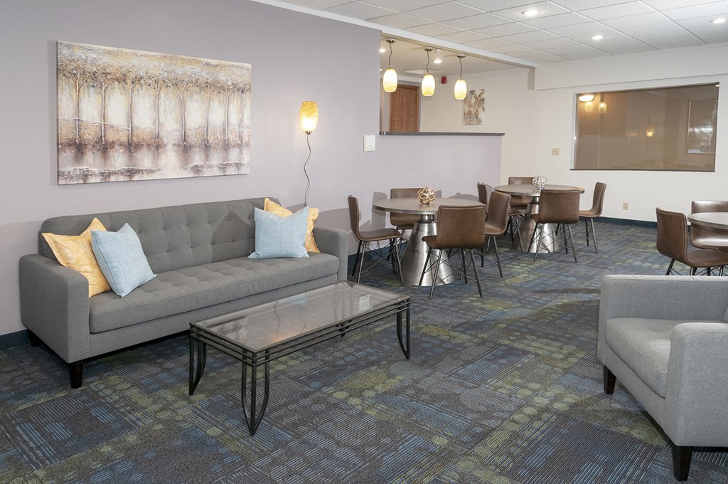 a living room with couches and chairs and a dining room with tables and chairs