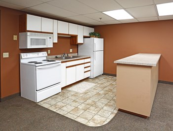 Kitchen with tile floor breakfast bar, white cabinets and appliances - Photo Gallery 2
