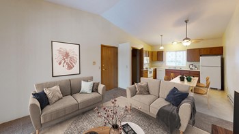 Comfortable and spacious living room with natural light from the doors leading out to the patio or balcony. - Photo Gallery 4