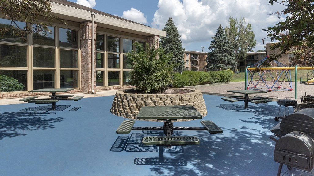 a fountain with a tree in the middle of it in front of a building