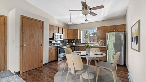 a kitchen and dining room with a table and chairs