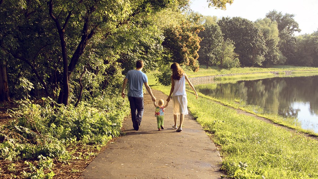 a family walking down a path with a child