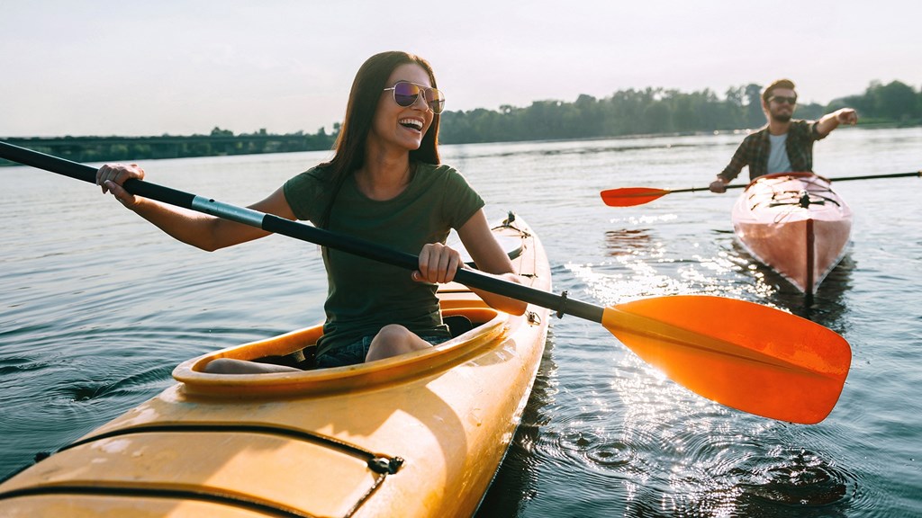 two people in kayaks on a lake