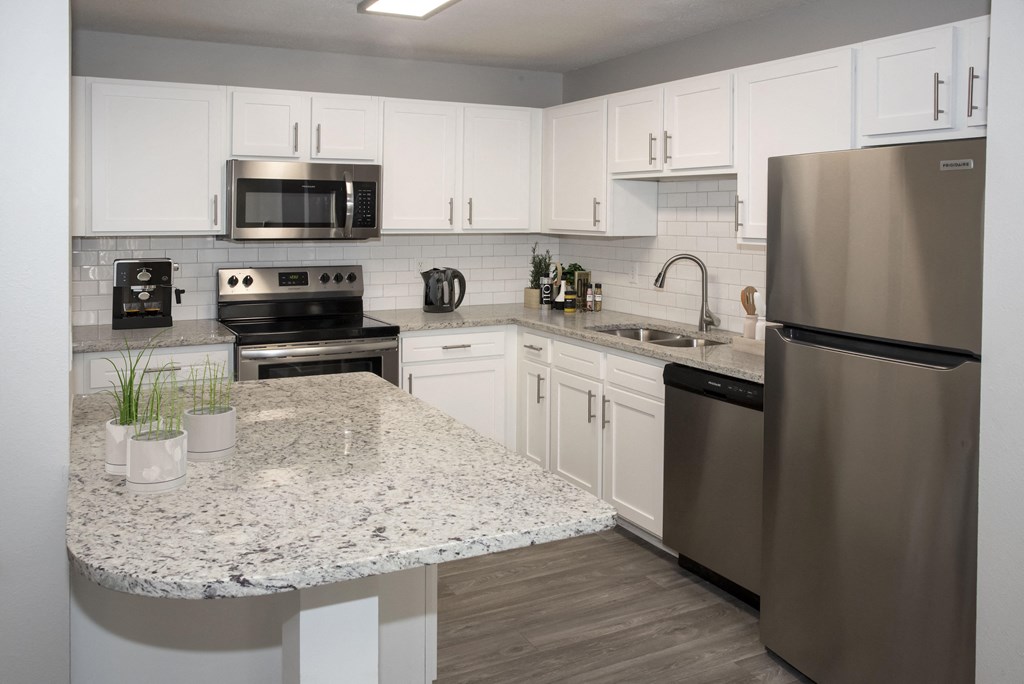 Full Kitchen with White Cabinets and Granite Counter Tops