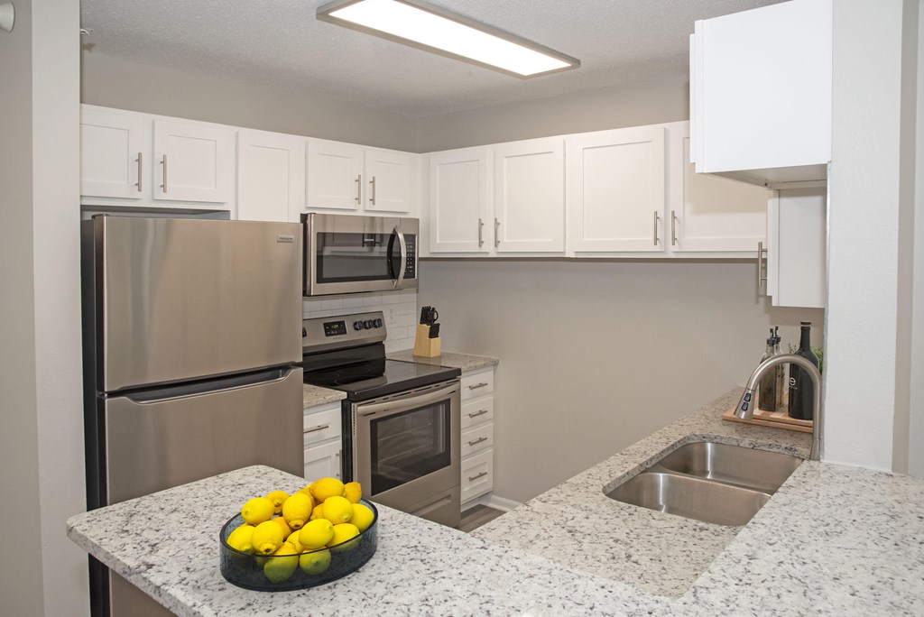 Full Kitchen with White Cabinets and Granite Counter Tops