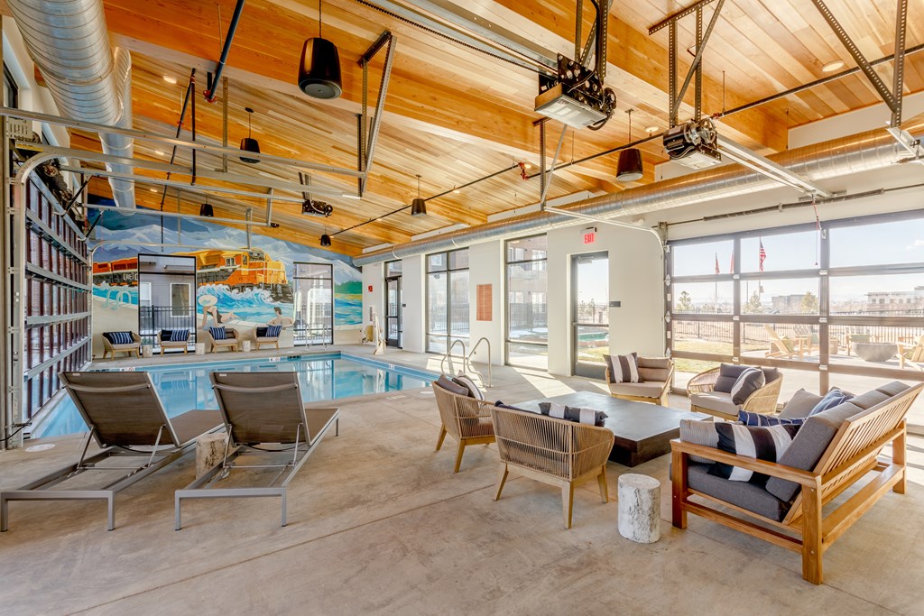 Indoor pool area with seating and mural