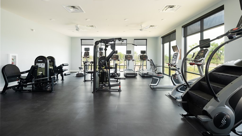 Fitness center with treadmills, stair master and weight machines.