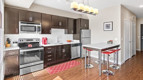 a modern kitchen with stainless steel appliances and a white counter top