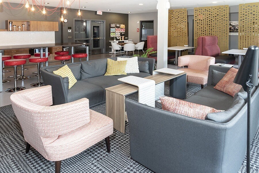 a seating area with couches chairs and tables