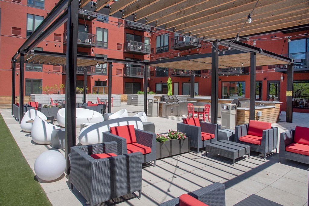 an outdoor patio with couches and chairs