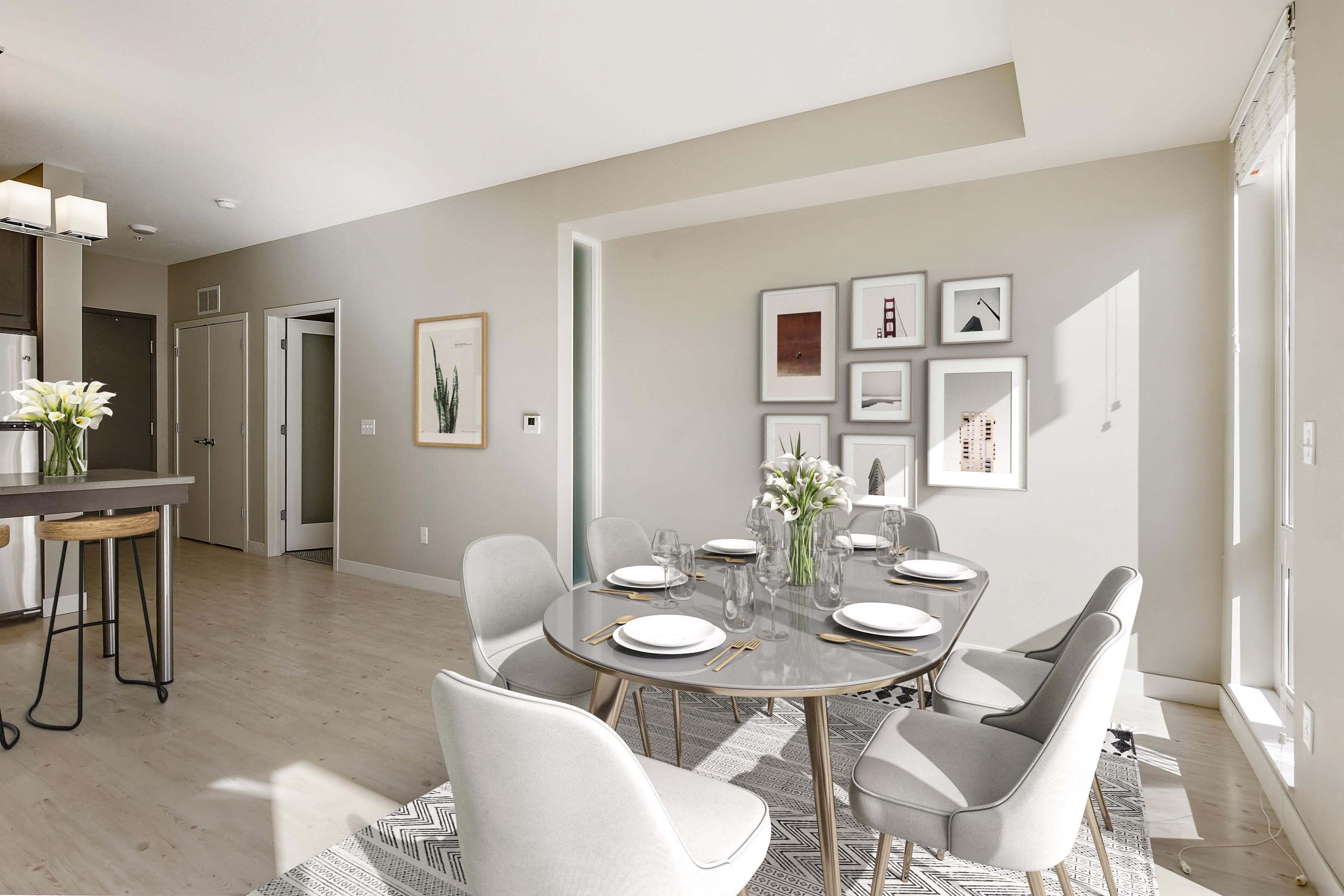 Elegant dining space lit by large window next to the table.