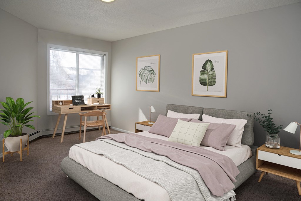 Spacious bedroom with a large window letting in natural light.