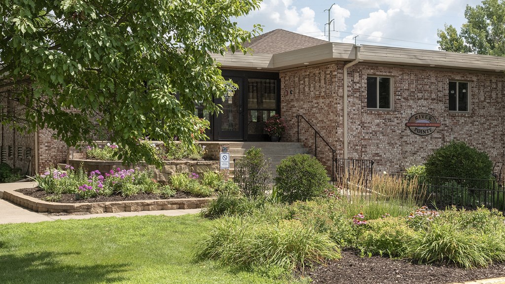 a brick building with a tree in front of it