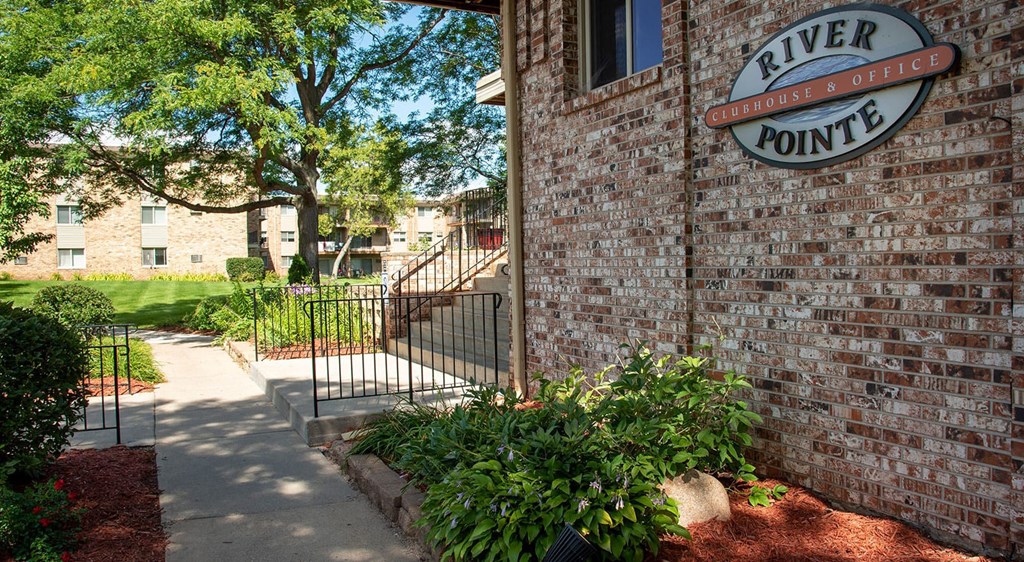 River Pointe sign on brick wall next to entryway