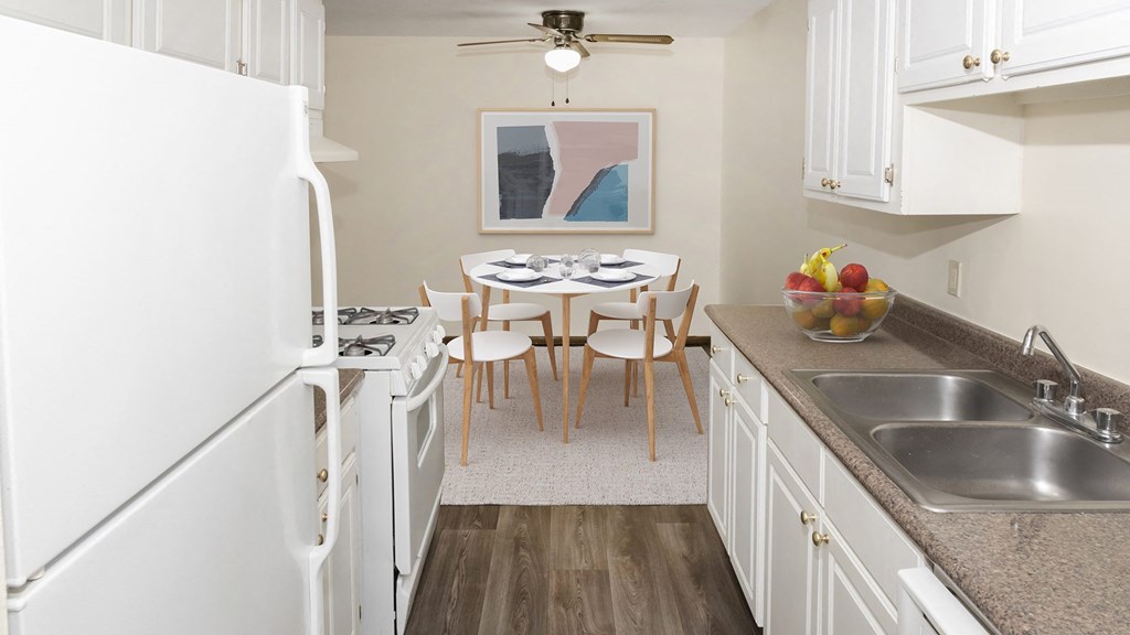 a kitchen and dining room with a table and chairs