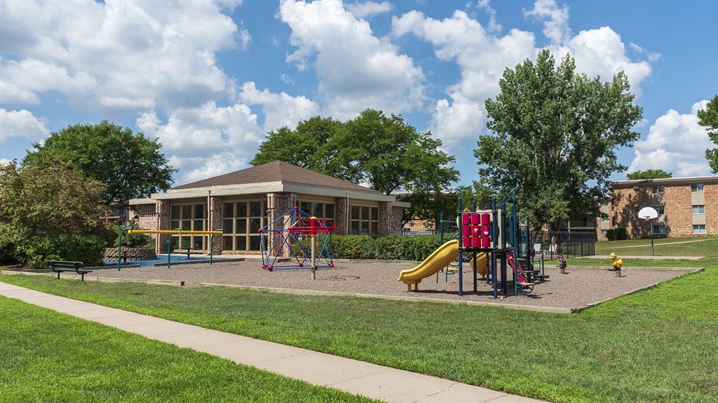 a playground with a building in the background